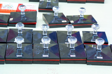 Many rubber stamps with clear handles and black bases are neatly arranged on a white surface