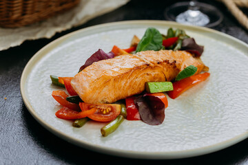 Grilled salmon fillet with fresh vegetables, served on a plate, elegant food presentation