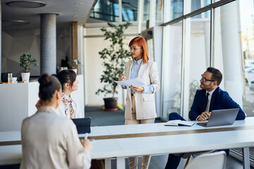 Businesswoman Leading a Meeting in a Modern Office Environment Focused on Collaboration