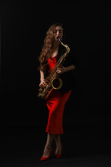 Obraz premium Professional musician playing saxophone on black background