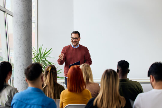 Speaker Engages with Audience During Interactive Business Training Session in Modern Setting