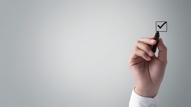 Marking success with a check office setting image of a hand professional environment close-up focus productivity concept