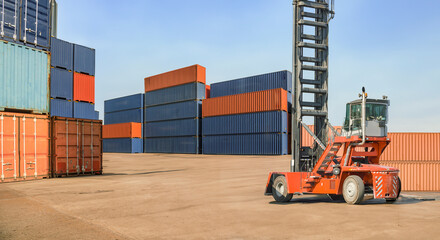 A forklift in a warehouse containing transport equipment and cargo containers