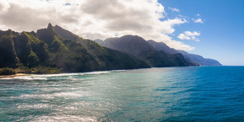 Aerial view of the Napali Coast on Kauai Island, Hawaii, with jagged green cliffs, turquoise...