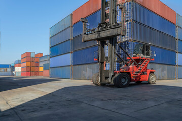 A forklift in a warehouse containing transport equipment and cargo containers