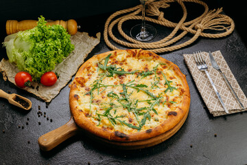Gourmet four-cheese pizza with arugula, served on a wooden board in a stylish restaurant setting