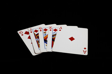 Straight Flush in a poker hand on a black background. Gambling card game.