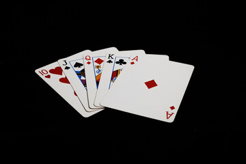 Straight in poker hand on a black background. Gambling card games.