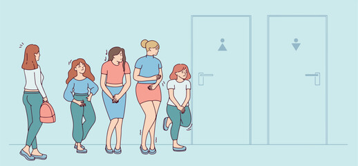 A queue of women waiting for the restroom while the men's restroom stands empty. Public restroom scene. © Sunflower