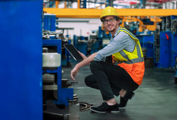 A worker in a warehouse maintaining machinery in a factory