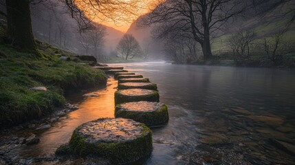 Serene river scene with stepping stones and misty landscape at sunset.
