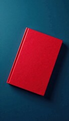 Fototapeta premium Red book cover floating on dark blue background, floating, color