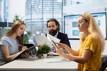 Financial advisor guiding parent and teenager in trading shares and making informed investment decisions. Consultant in office doing presentation on buying and selling stocks to optimize returns