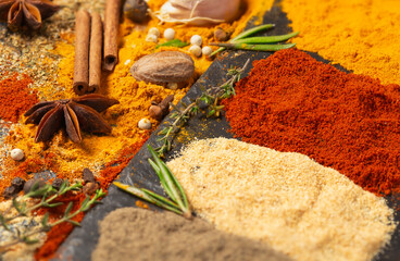 Scattered spices: turmeric, paprika, cardamom, nutmeg, black and allspice