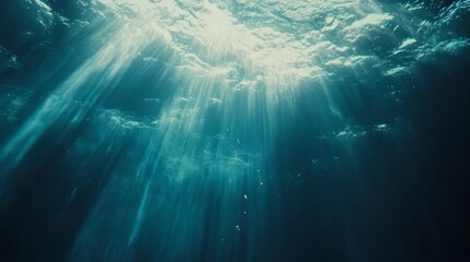 Fototapeta premium Underwater ocean view, sunlight beams penetrating through the water, soft blue gradient, realistic rippling surface, soft light rays, photography style