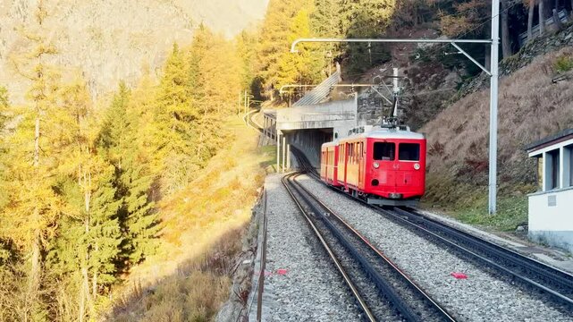 Chamonix, France - 1 November 2024: A ride on the iconic red Montenvers train in Chamonix, leading to the Alpine glacier. Breathtaking views of the mountains, the town below, and vibrant autumn trees.