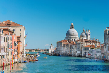 The Grand Canal, with gondolas, boats, ancient buildings and palaces. It is the main navigation channel linking Basin São Marcos to the Santa Lucia railway station. Venice, Italy, 2019