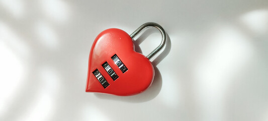 Locking away love heart-shaped combination lock minimalist background conceptual photography