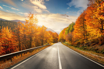 Fototapeta premium Beautiful rural road in autumn season forest. Royalty high-quality free best stock of Scenic autumn Winding road with colorful foliage, amazing landscape nature, fall color trees woods