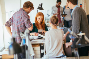Group of young architects working on a project together in the office