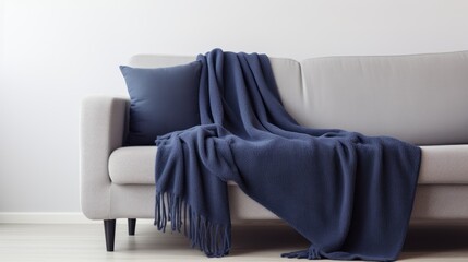 Cozy blue blanket and pillow on a modern sofa in minimalist home