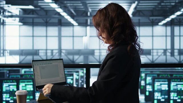 Admin in data center using laptop to update storage arrays, configuring network virtualization. Woman in server room holding coffee cup, verifying settings to maintain stable performance, camera B