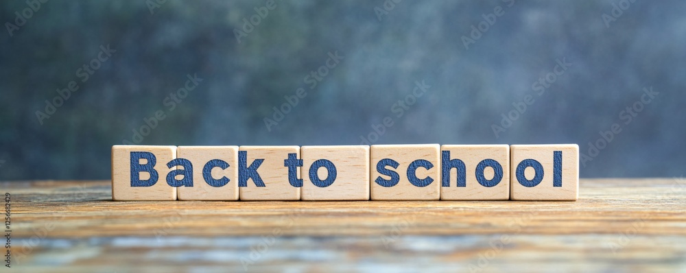 Poster back to school concept with wooden blocks on a table