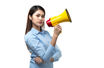 Beautiful young Asian woman wearing blue shirt casual clothes hold yellow in hand megaphone scream...