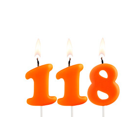 Lit birthday candle - Candle number 118 on white background.