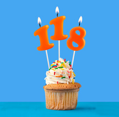 Orange birthday candle and cupcake - Number 118.