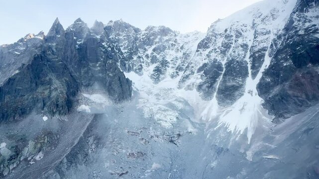 View from the cable car ascending to the upper station of Aiguille du Midi, showcasing stunning alpine landscapes and snow-covered peaks.
