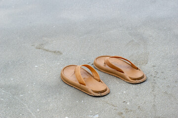 a pair of flip-flops on the beach sand