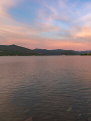 Beautiful sunset over a lake with mountains in the background