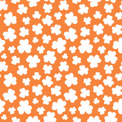St Patricks Day pattern with shamrocks. Seamless orange background and white clover leaves. Saint Patricks March 17 holiday backdrop. Vector flat illustration