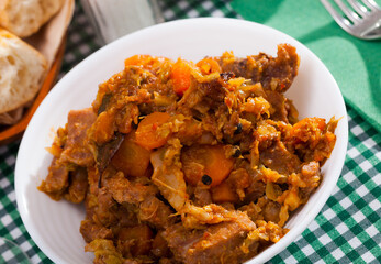 Tasty stew of cabbage with boneless pork and sliced carrots..