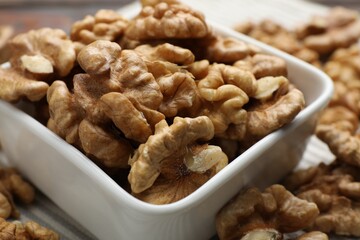 Peeled walnuts in bowl on table, closeup