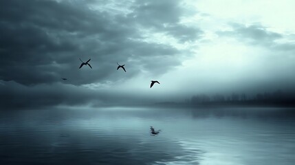 Calm birds flying over a misty lake at dawn. Suitable for nature, serenity, and tranquility