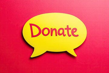 Fototapeta premium Yellow Speech Bubble with Donate Text on Red Background A Call to Action for Charitable Giving
