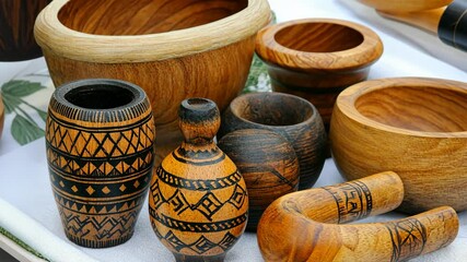 Handcrafted wooden bowls and decorative items displayed at a local market in summer