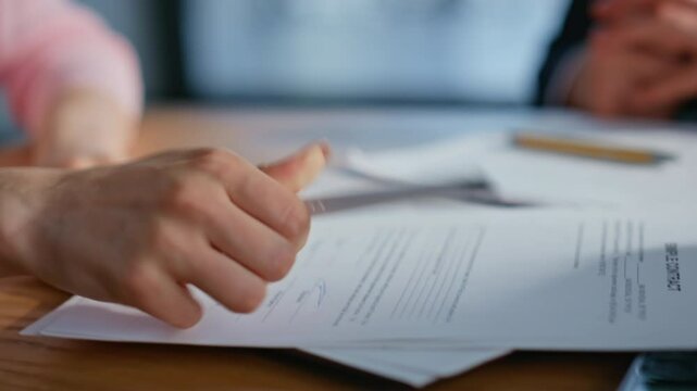 Corporate partner signing agreement at office desk closeup. Woman shaking hands