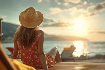 A woman in a straw hat enjoys a sunset by the beach, embodying relaxation and tranquility amidst a beautiful coastal landscape.