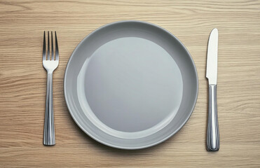 Simple Place Setting with Gray Plate Fork and Knife on Wooden Table