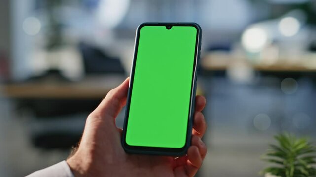 Businessman using chromakey smartphone making online order at workplace closeup.