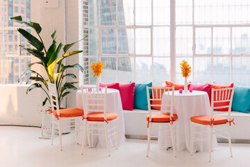 Bright and airy event space with vibrant decor and natural light for gatherings in a modern urban...