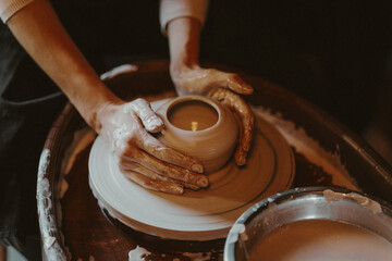 Person Working on a Clay Wheel, Shaping the Beginning of a Pot