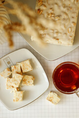 Sliced sherbet with a cup of tea on the table, close-up