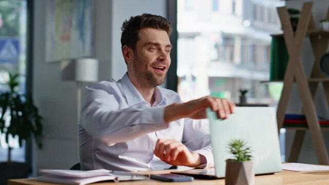 Smiling employee closing laptop feeling satisfied of project at office closeup.