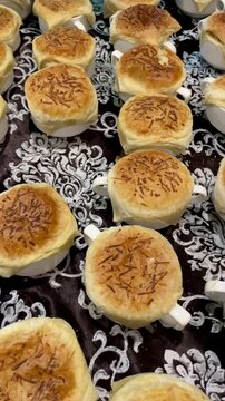 A row of cooked zuppa soup food on the table ready to be served. Cereal porridge food in bread crust placed in a small bowl