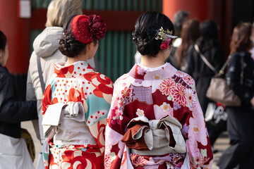 Young girl wearing Japanese kimono standing in front of Sensoji Temple in Tokyo, Japan. Kimono is a Japanese traditional garment. The word "kimono", which actually means a "thing to wear"