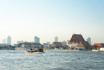 Naklejka premium Wat Kanlayanamit Buddhist temple on the bank of the Chao Phraya River early morning in Bangkok